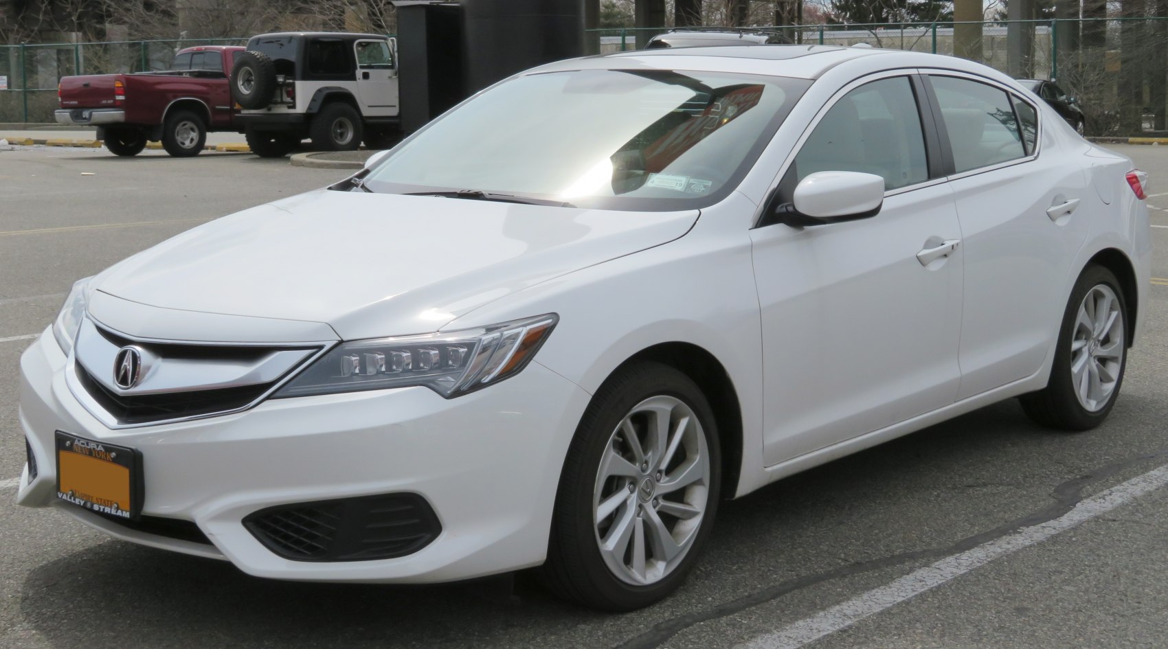 Front-side view with LED headlights and alloy wheels on a white sedan
