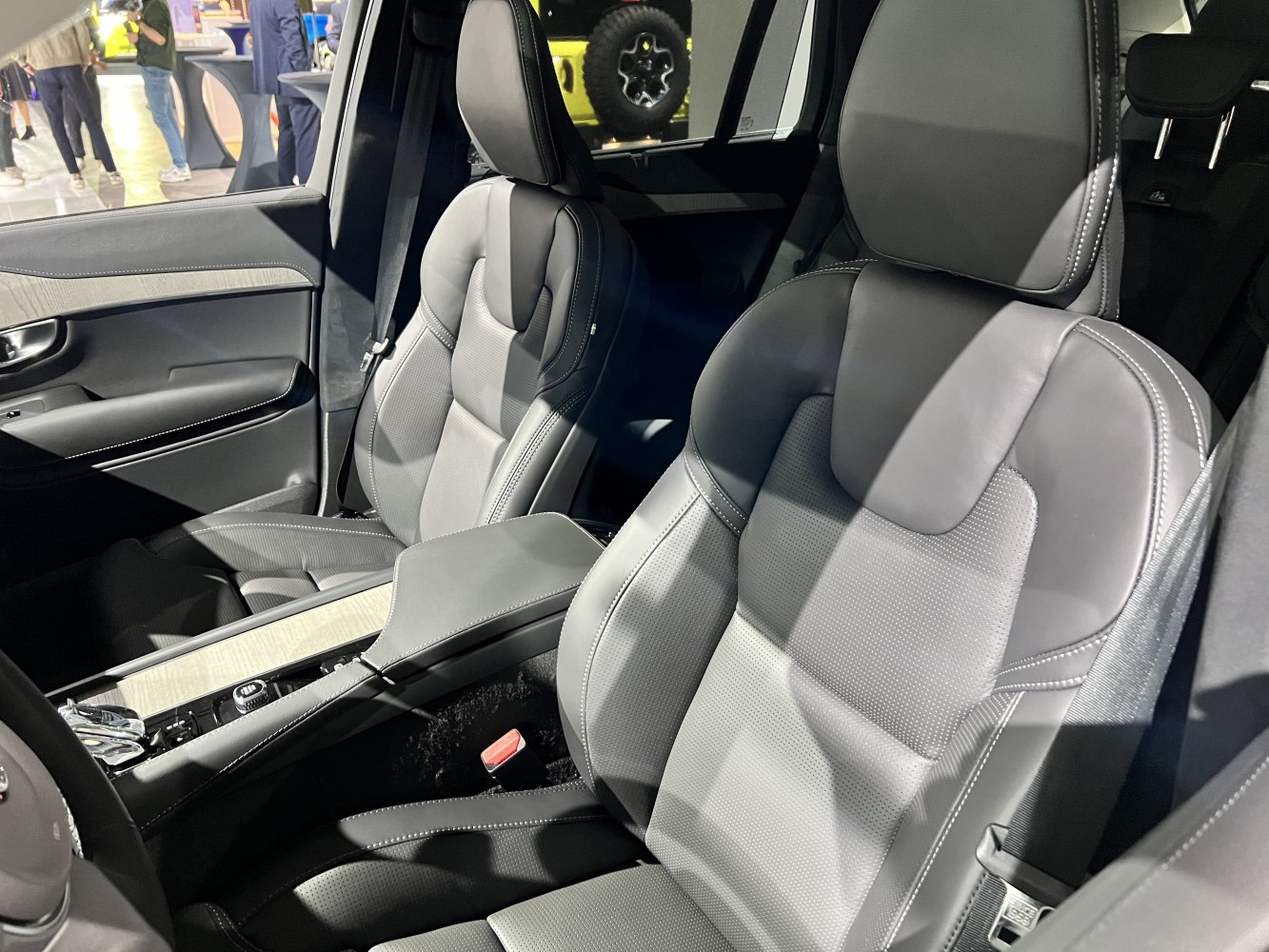 Premium perforated leather seats with center console and armrest in luxury SUV