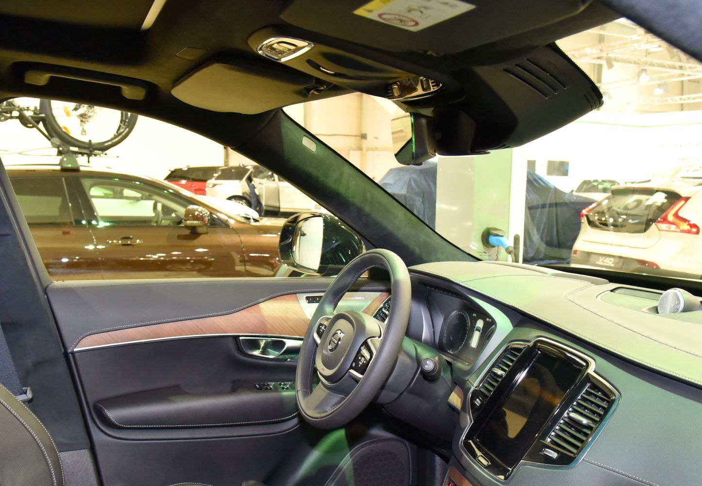 Luxury SUV interior with wood trim, digital dashboard, multifunction steering wheel.