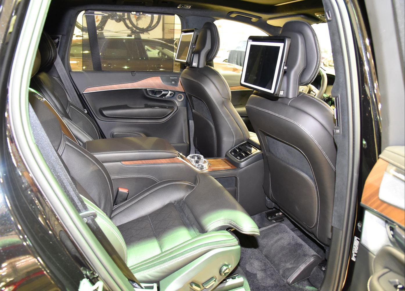 Rear seats with built-in screens and adjustable leg rest in premium SUV interior