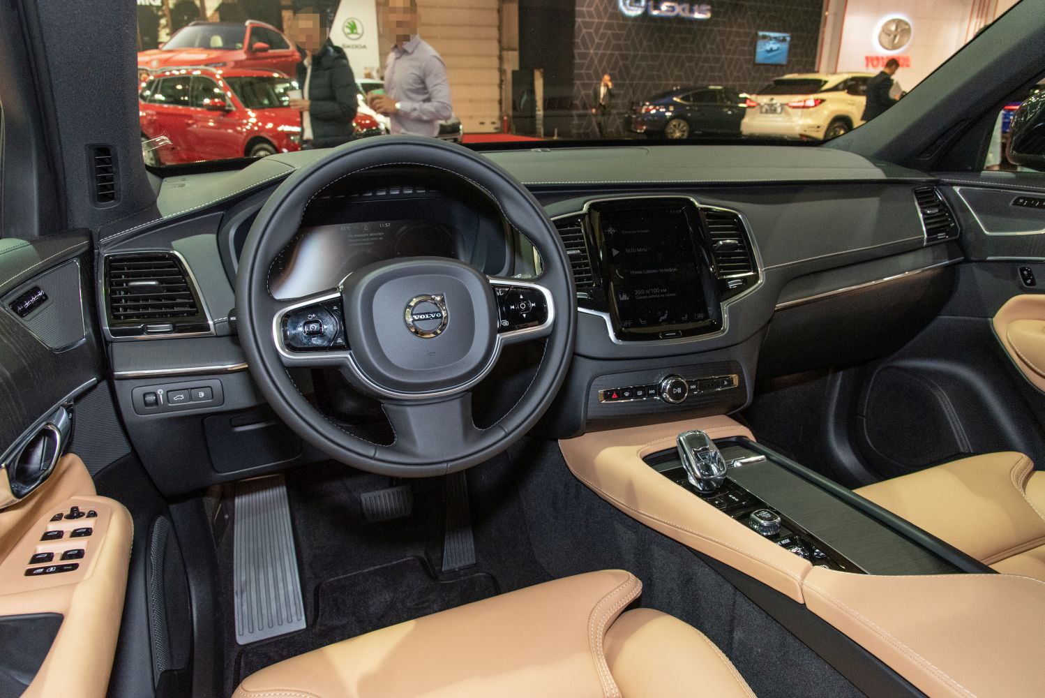 Steering wheel, digital dashboard, and tan leather center console interior