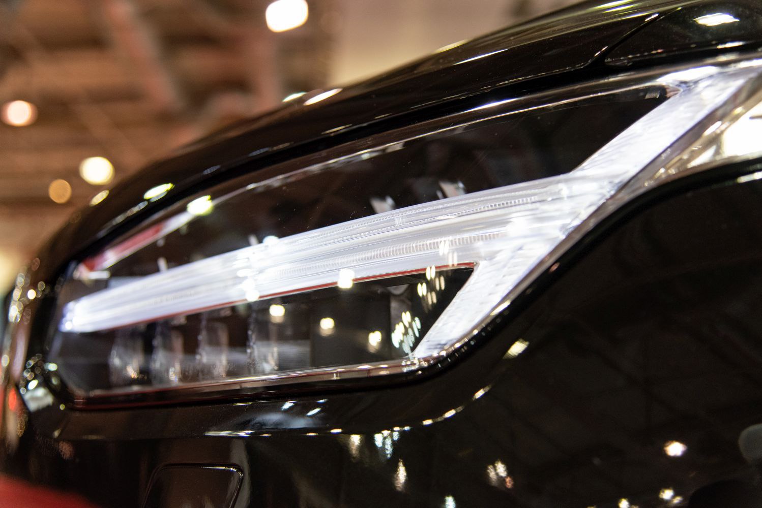 Close-up of a modern LED headlight with sleek, angular design.
