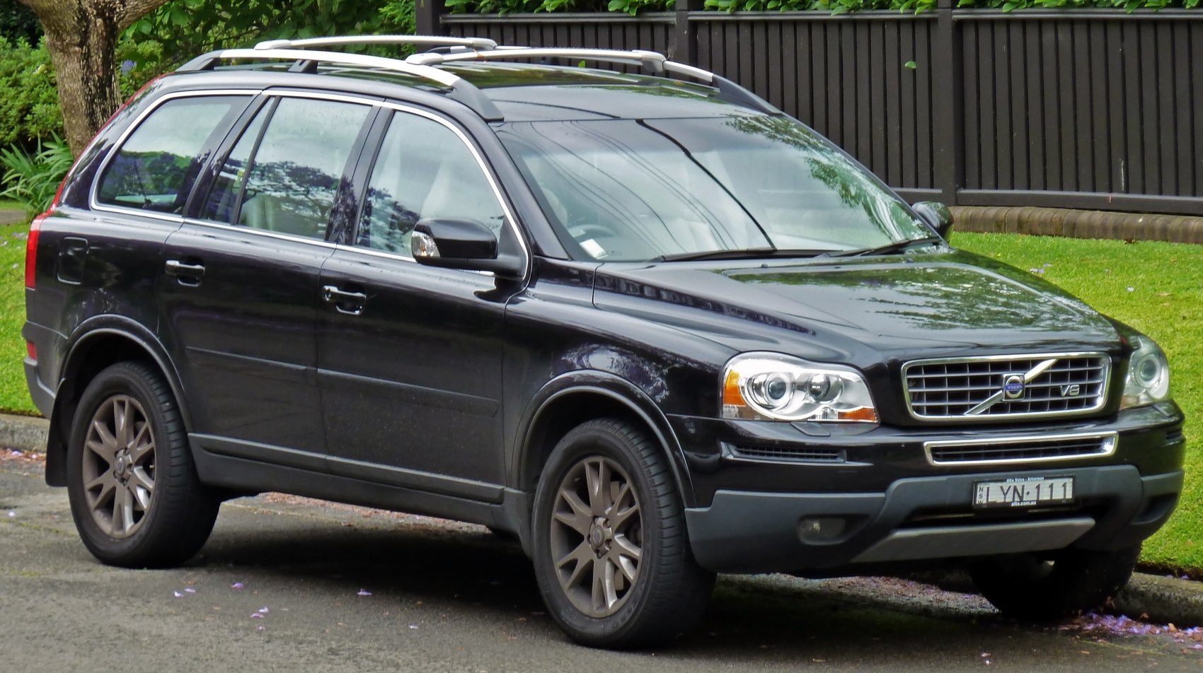 Front side view of an SUV with distinctive grille and rugged wheels