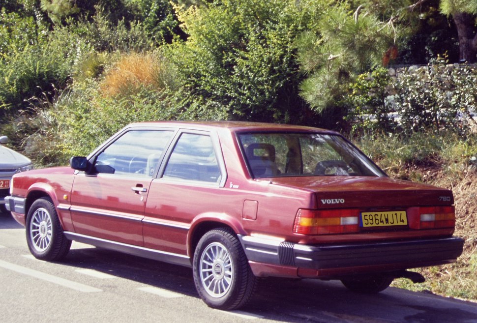 Rear side view of a vintage two-door coupe with distinctive tail lights and robust bumper.