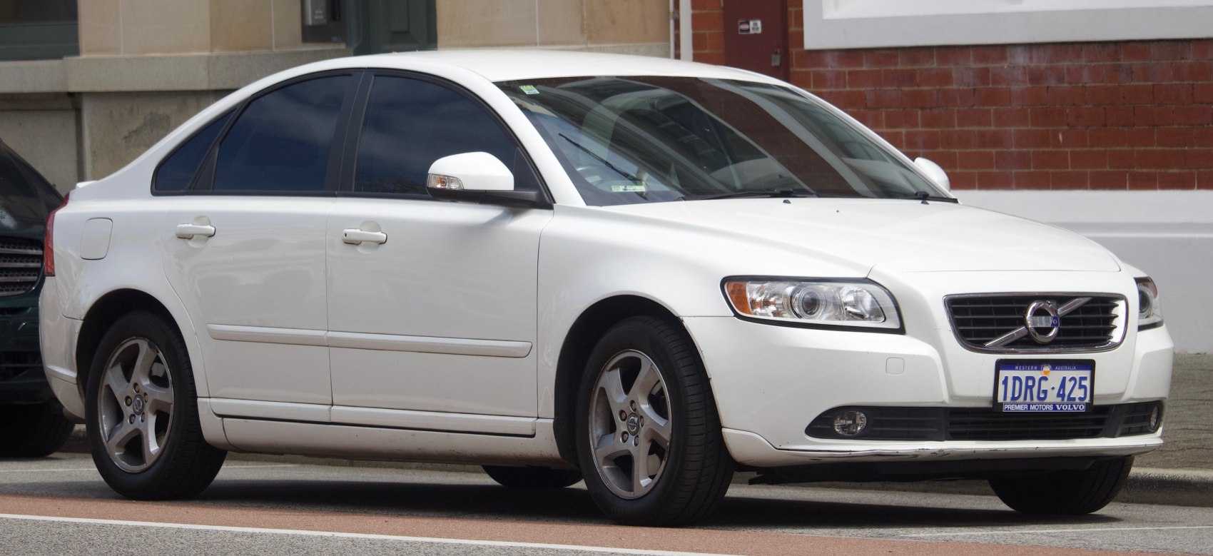 White 4-door sedan with alloy wheels and smooth body lines