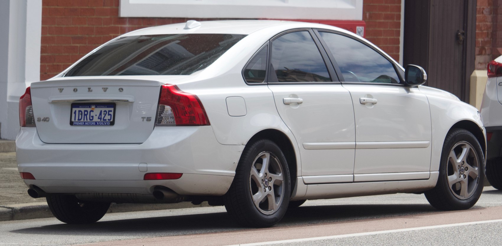 Rear side view of a white sedan with distinctive rear tail lights and T5 emblem