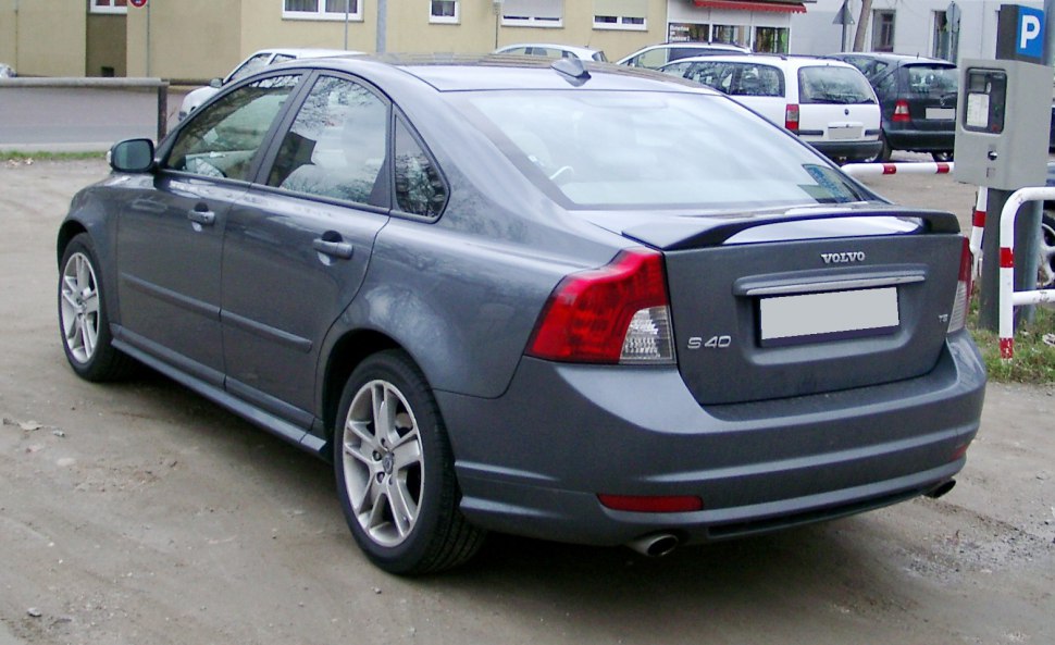 Rear and side view of a grey sedan with distinct tail lights and alloy wheels