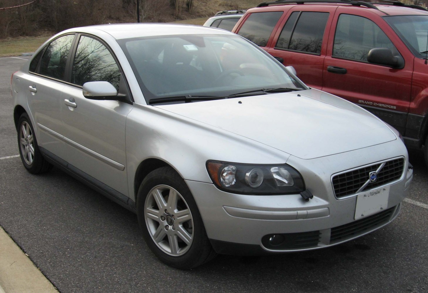 Silver sedan front side view with distinct grille and headlights