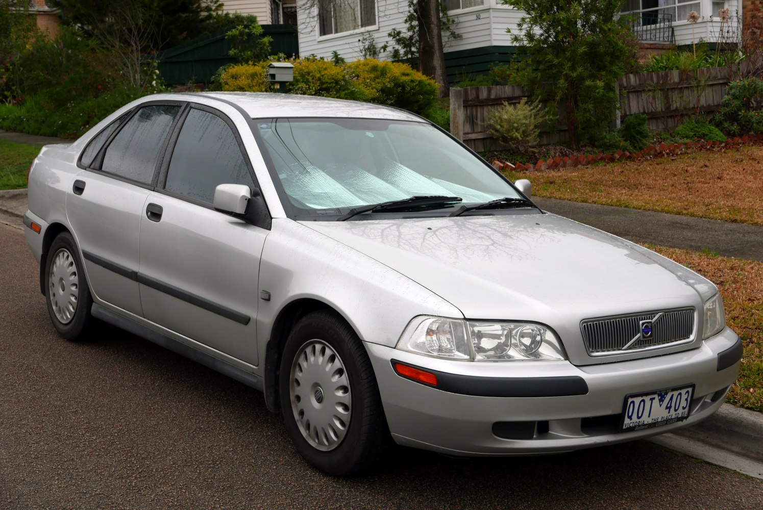 Silver sedan with classic front grille and headlights.