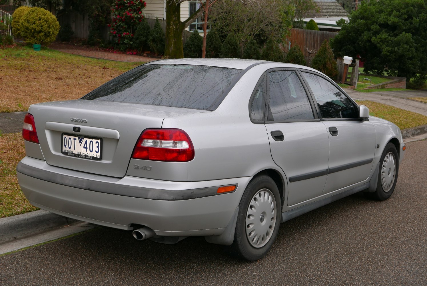 Silver sedan rear side view with distinct taillights and smooth design