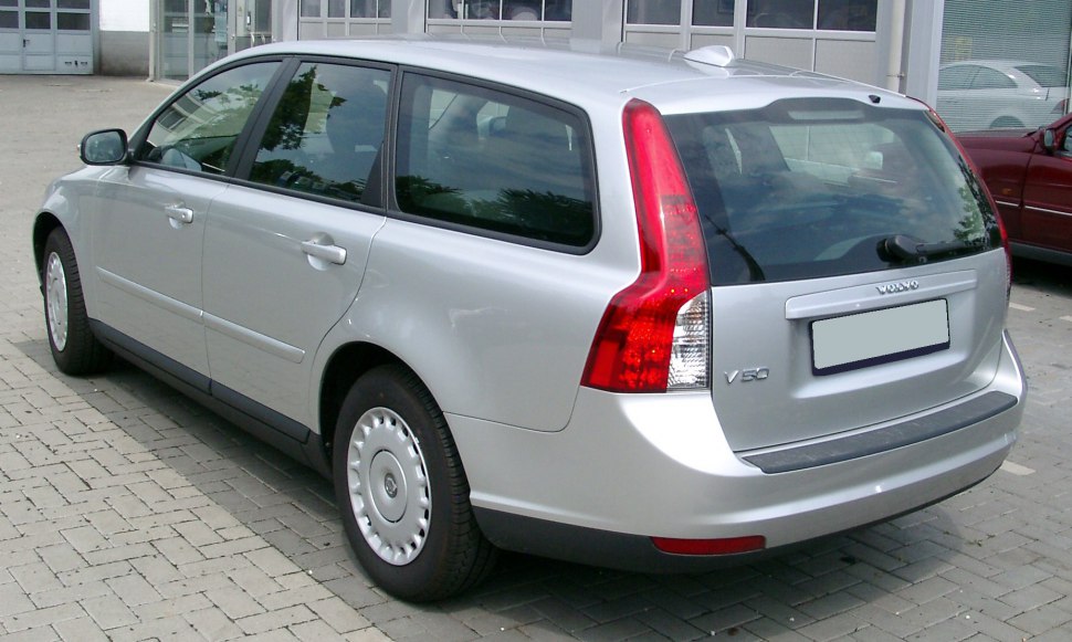Silver station wagon rear three-quarter view with prominent vertical taillights