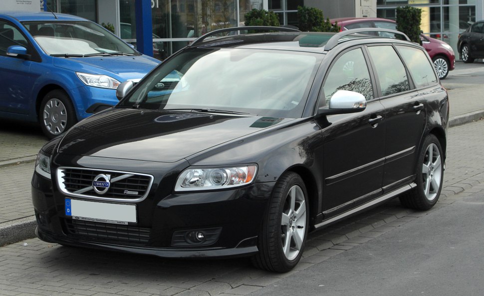 Black station wagon with roof rails and alloy wheels.