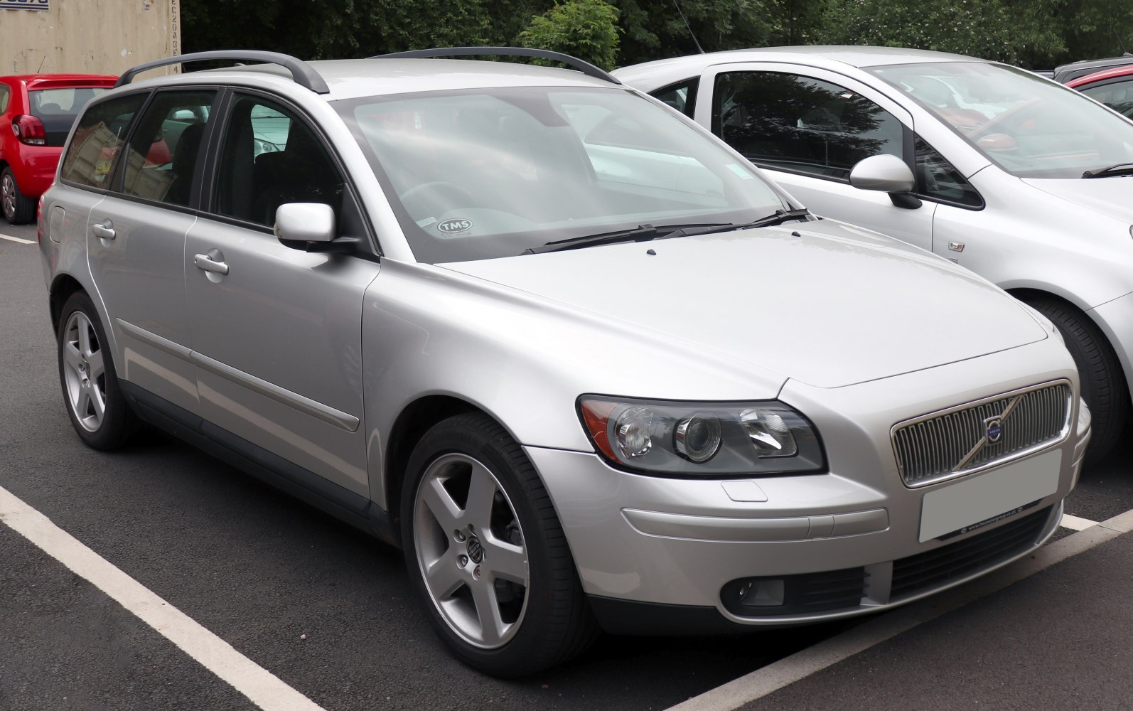 Silver station wagon with alloy wheels and roof rails, front side angle