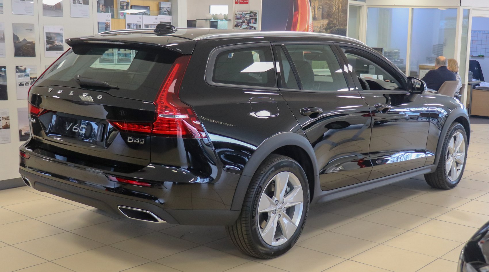 Glossy black rear side profile with distinct taillights and alloy wheels