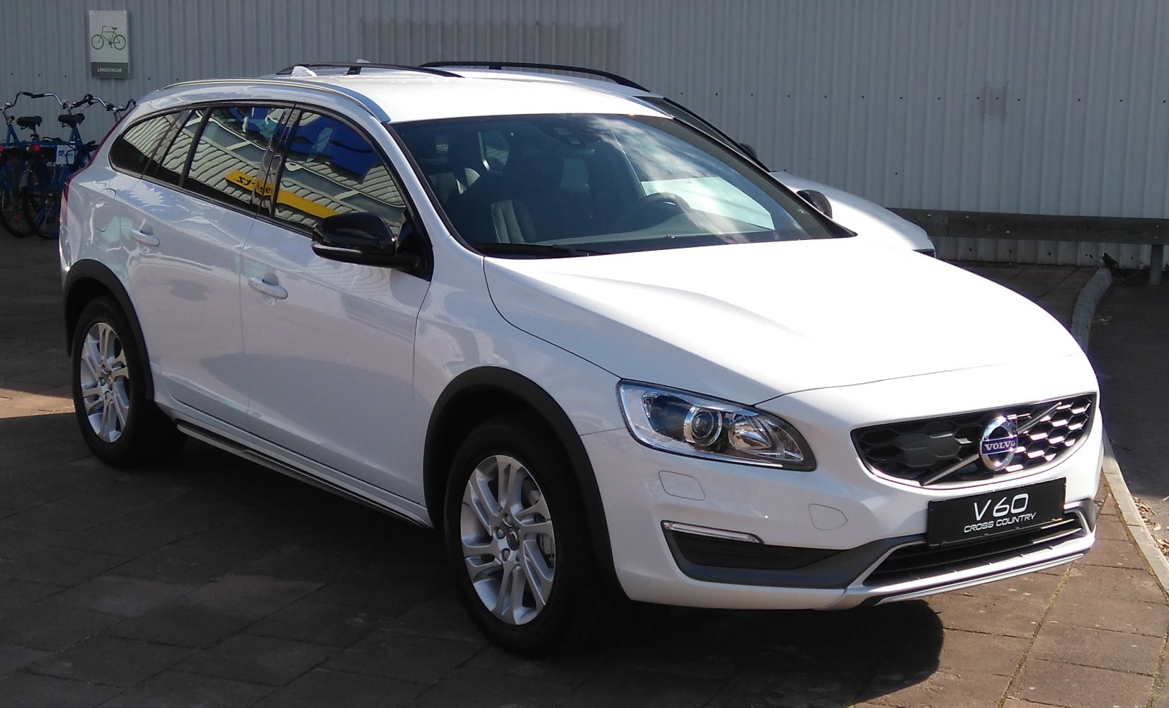 White wagon with front grille and headlights, roof rails visible