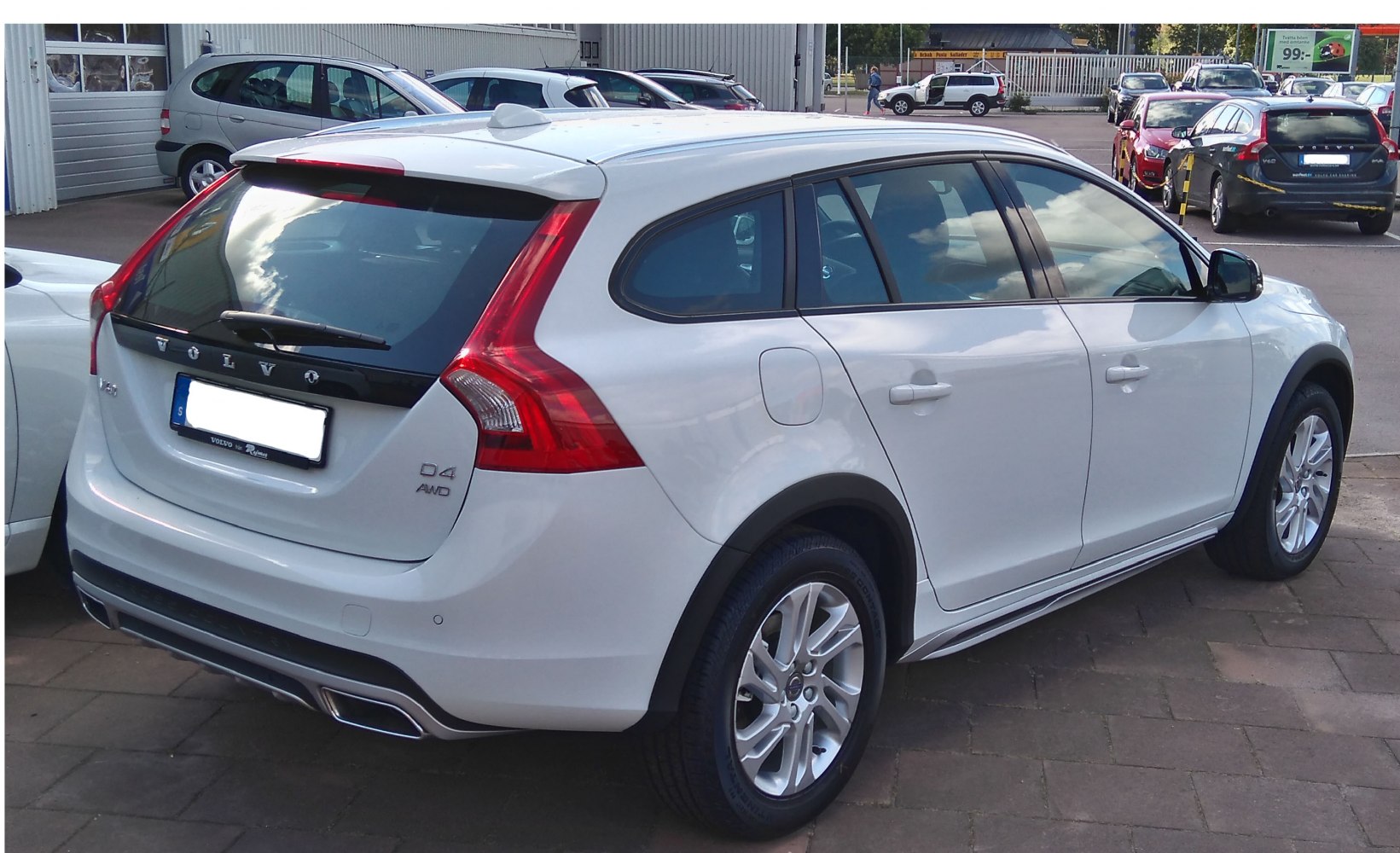 Rear and side view of white estate vehicle with signature tail lights and AWD badge