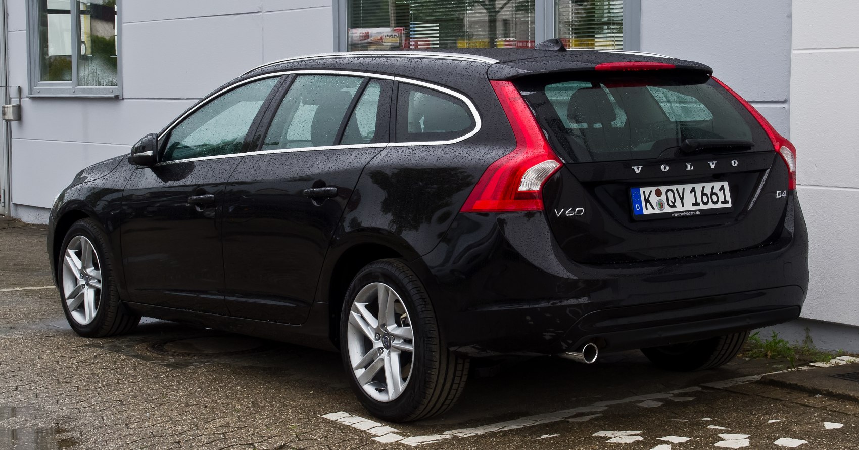 Rear side view of black modern station wagon with vertical taillights and alloy wheels