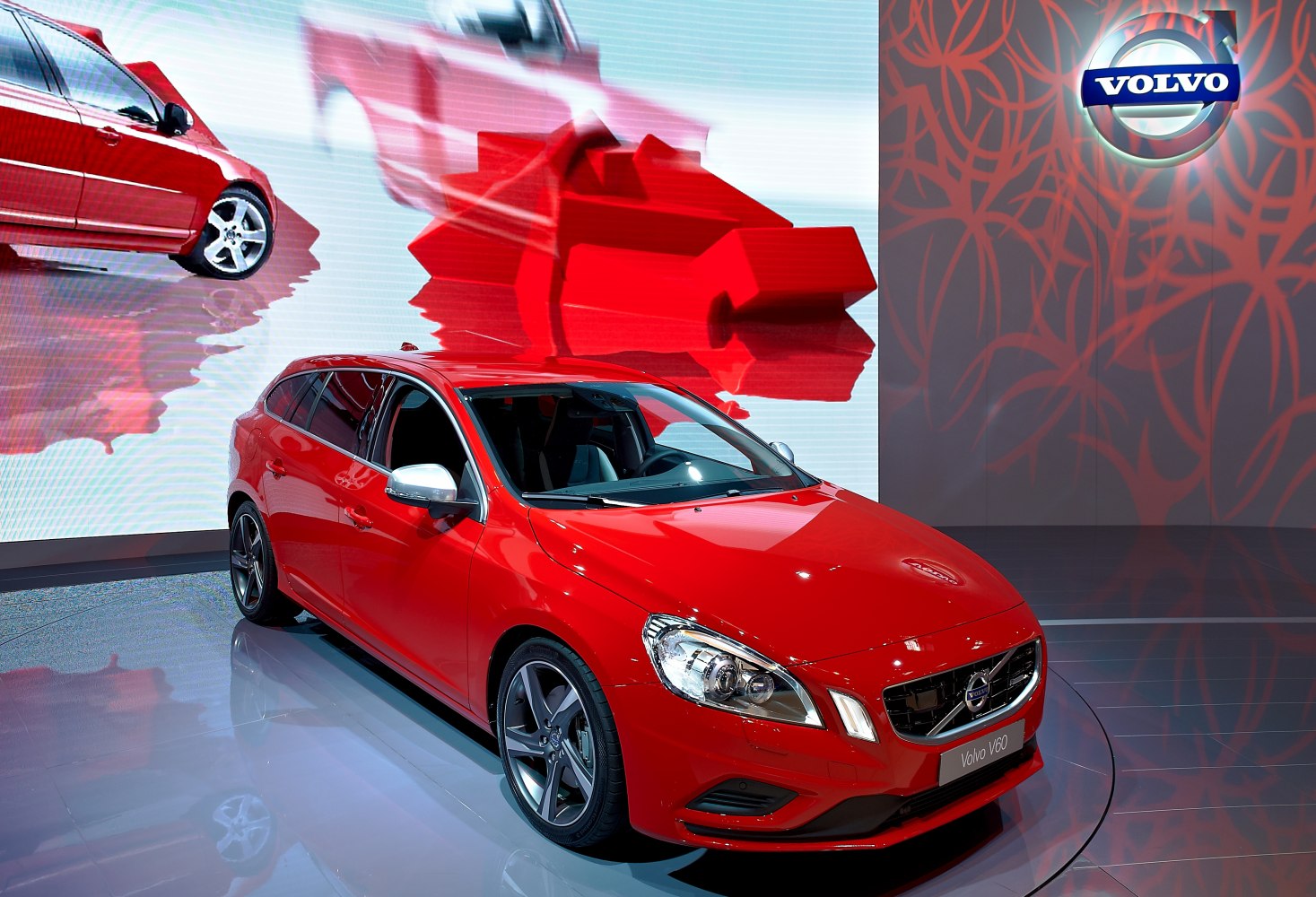 Red hatchback front-side view with detailed headlights and alloy wheels