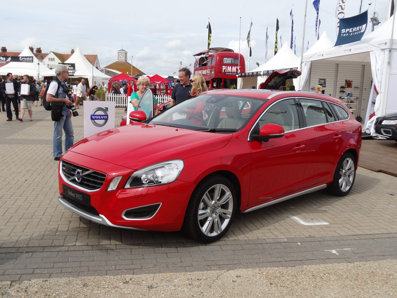 Red station wagon front and side view with alloy wheels