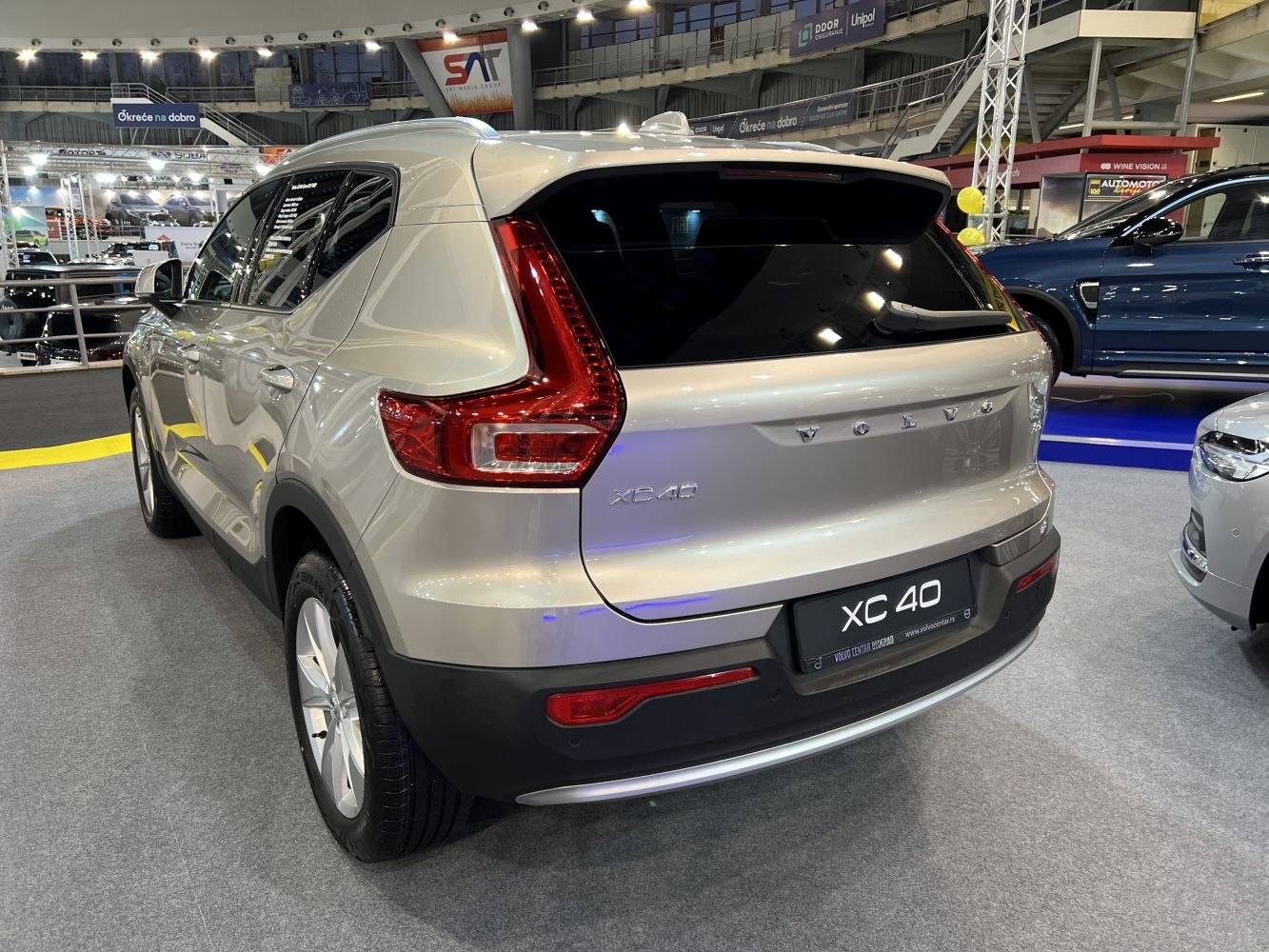 Silver SUV rear view with distinctive tail lights and black lower bumper