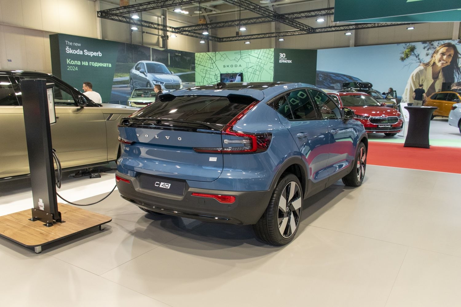 Rear and side view of blue electric SUV charging