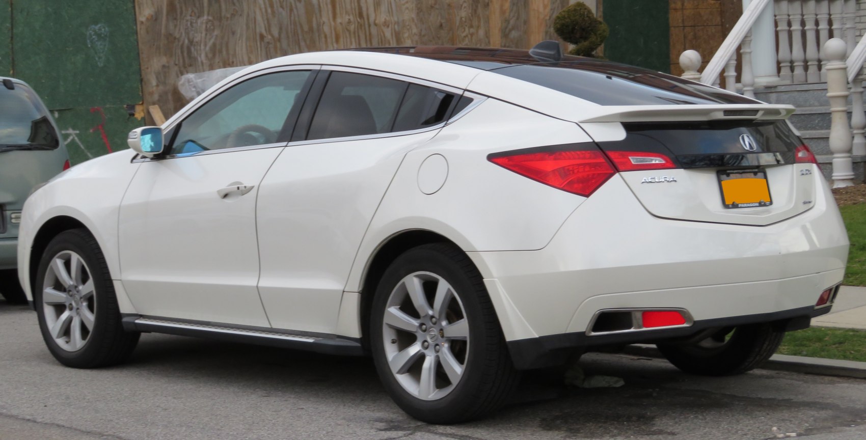 Rear side view with distinctive spoiler and angular taillights
