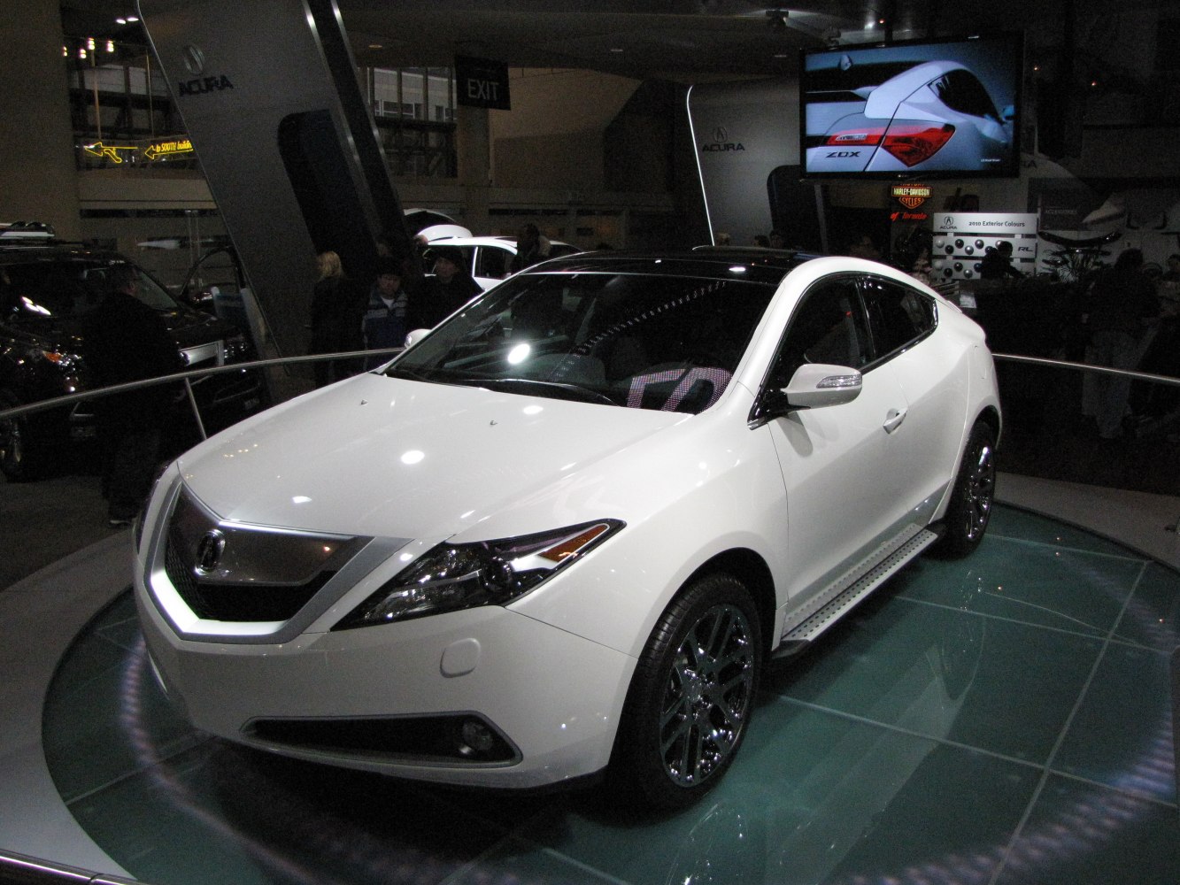 White SUV with sleek front angle, chrome wheels, and tinted windows