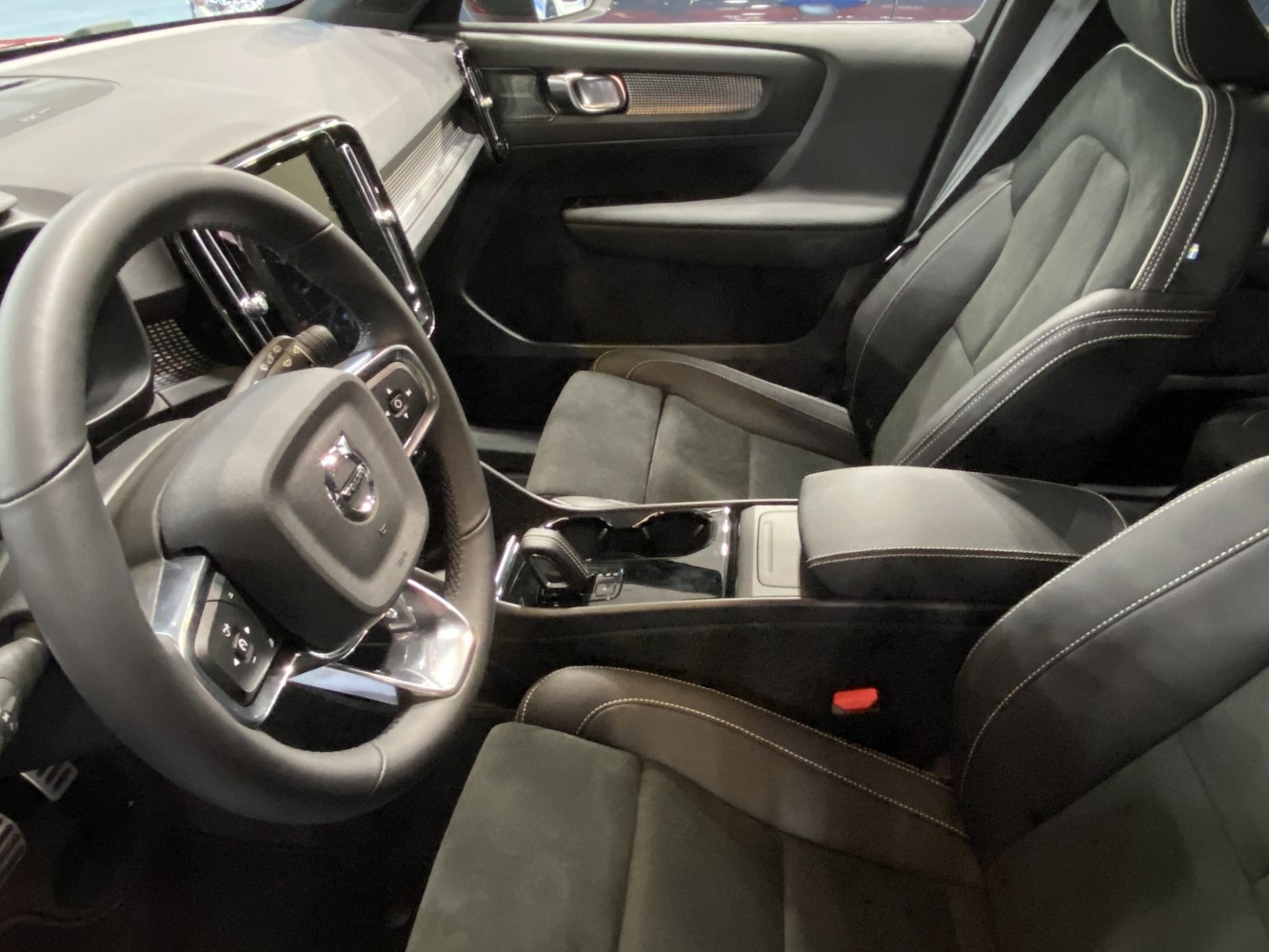 Close-up of steering wheel, dashboard, and front seats in modern car interior