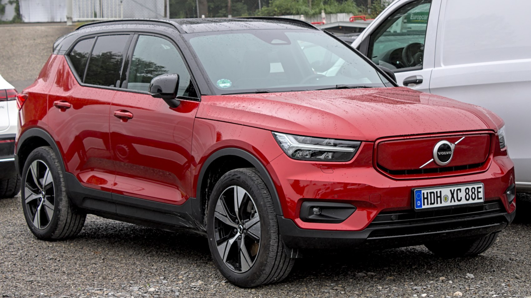 Red SUV with LED headlights and unique front grille design.