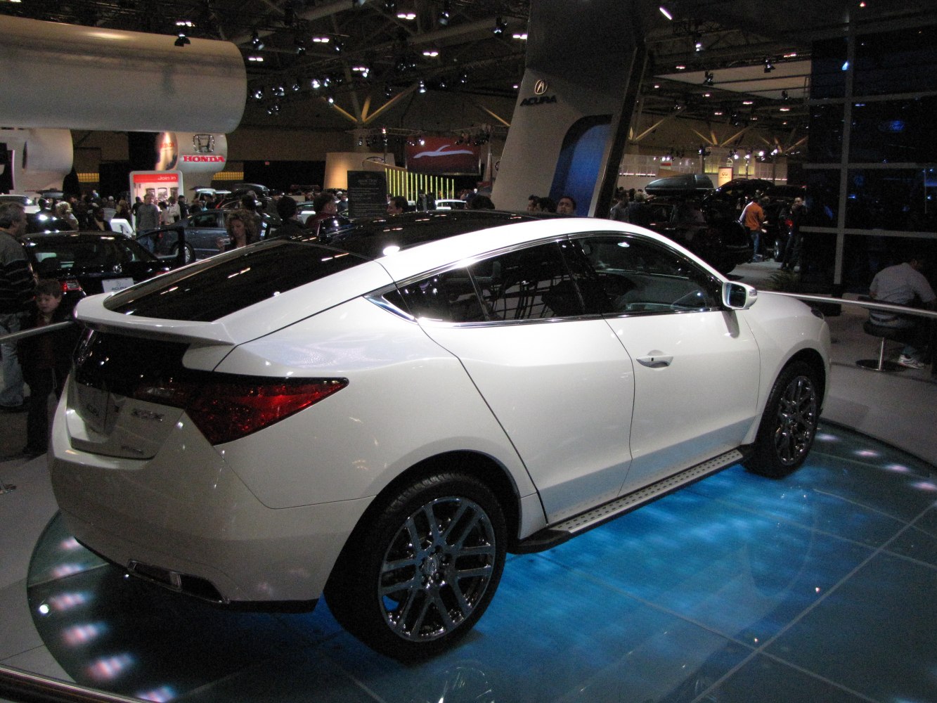 Sleek coupé SUV rear profile with sharp tail lights and tinted windows