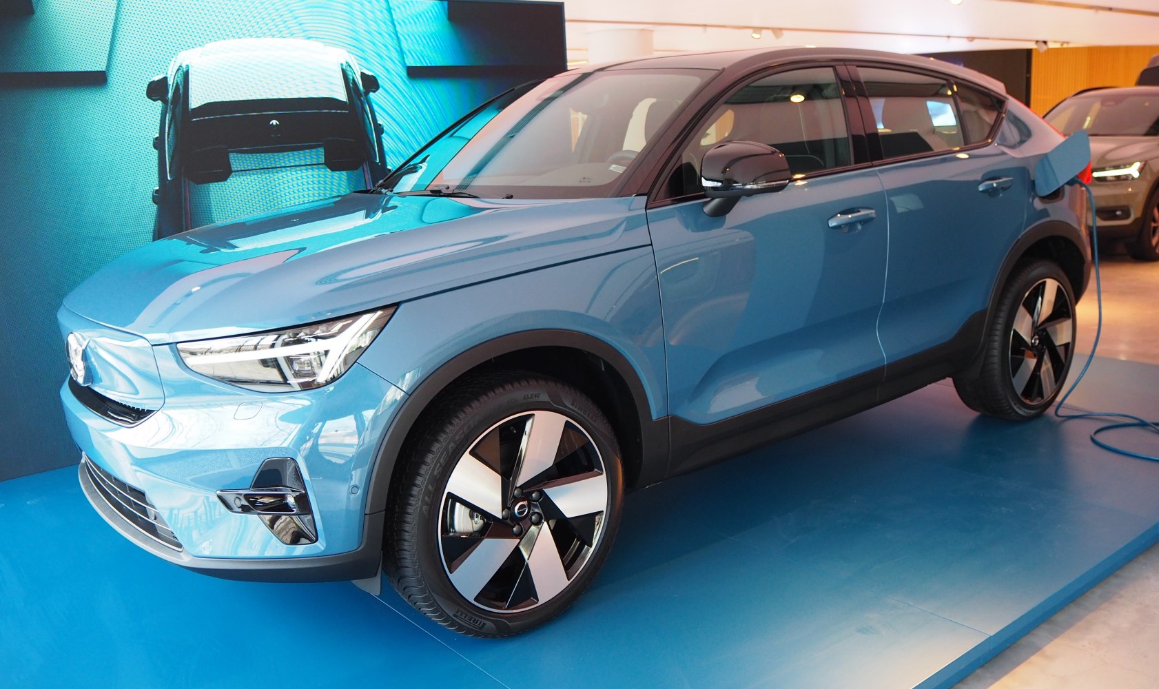Electric compact SUV with LED daytime running lights and rear charging port