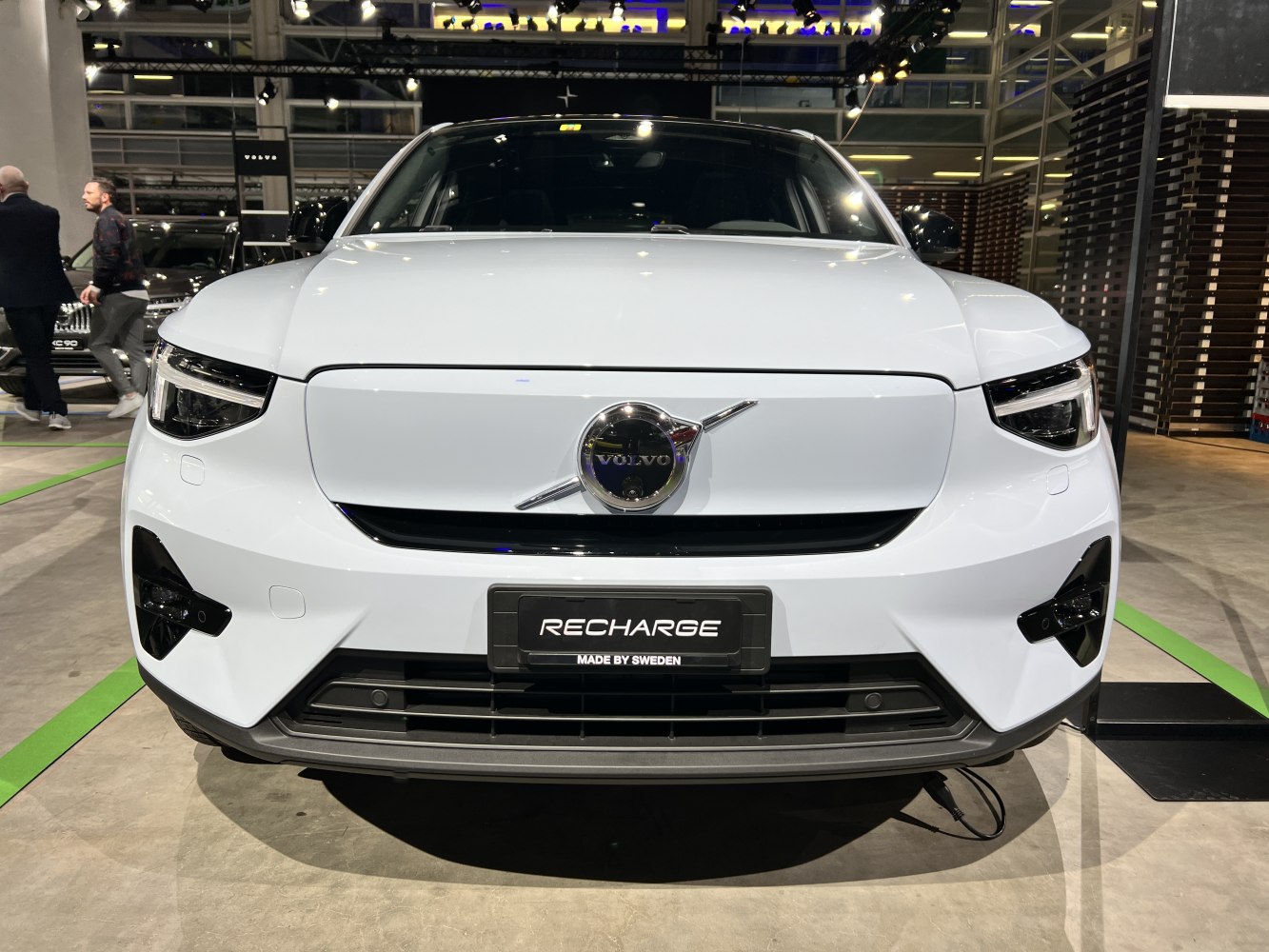 Electric SUV front with distinctive grille, badge, and headlights