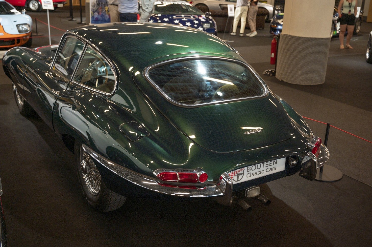 Classic 1960s sports car rear with chrome bumper and wire wheels
