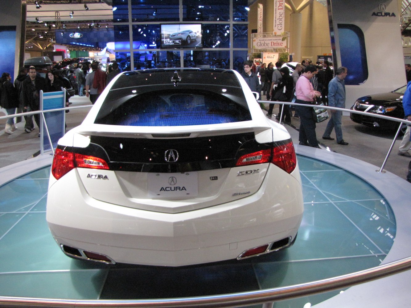 Rear view with distinctive taillights, spoiler, and dual exhaust tips