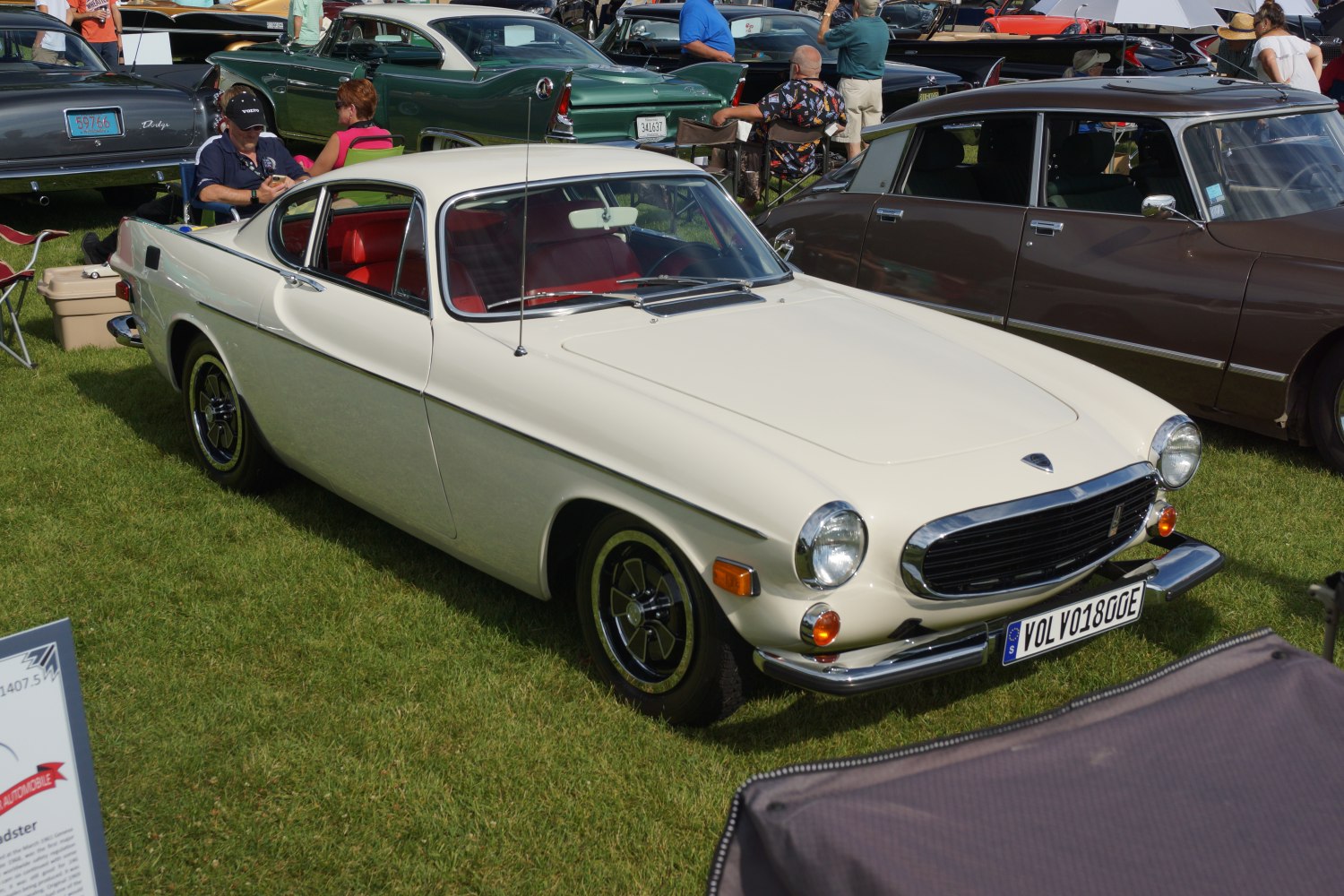Classic white coupe with chrome grille and round headlights.