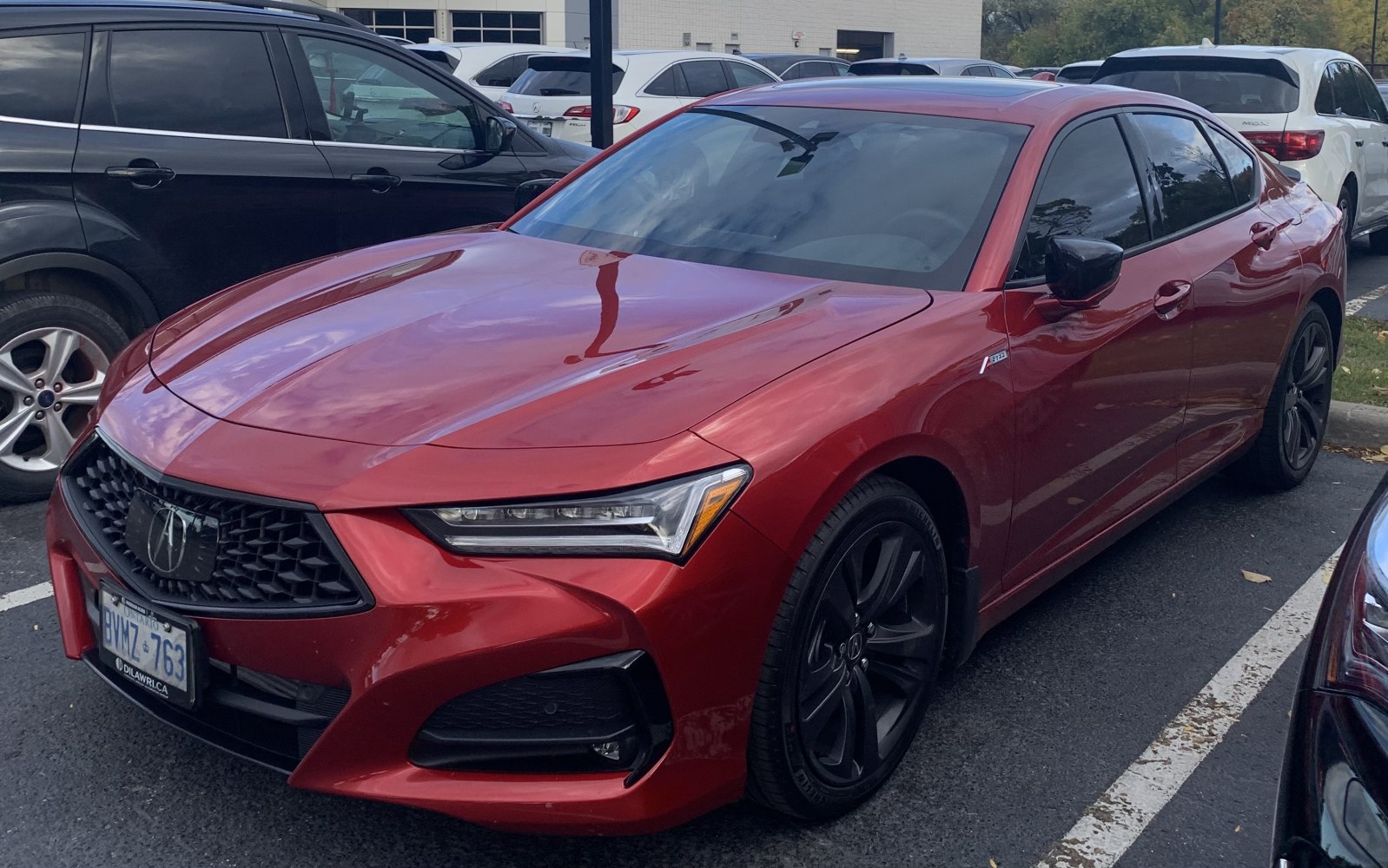 Red sedan with sharp grille and sleek LED headlights