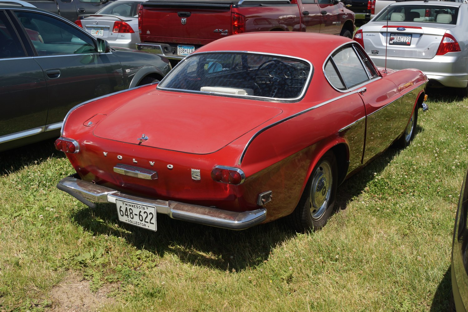 Rear view of a vintage classic coupe with curved design and chrome bumper