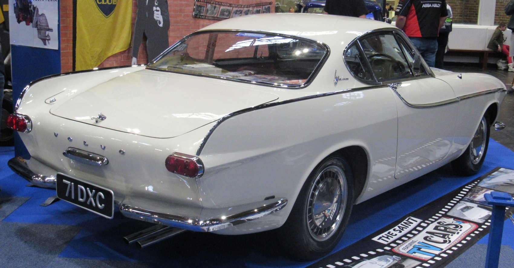 Rear and side view of a classic 1960s coupe with chrome trim and rounded tail lights.