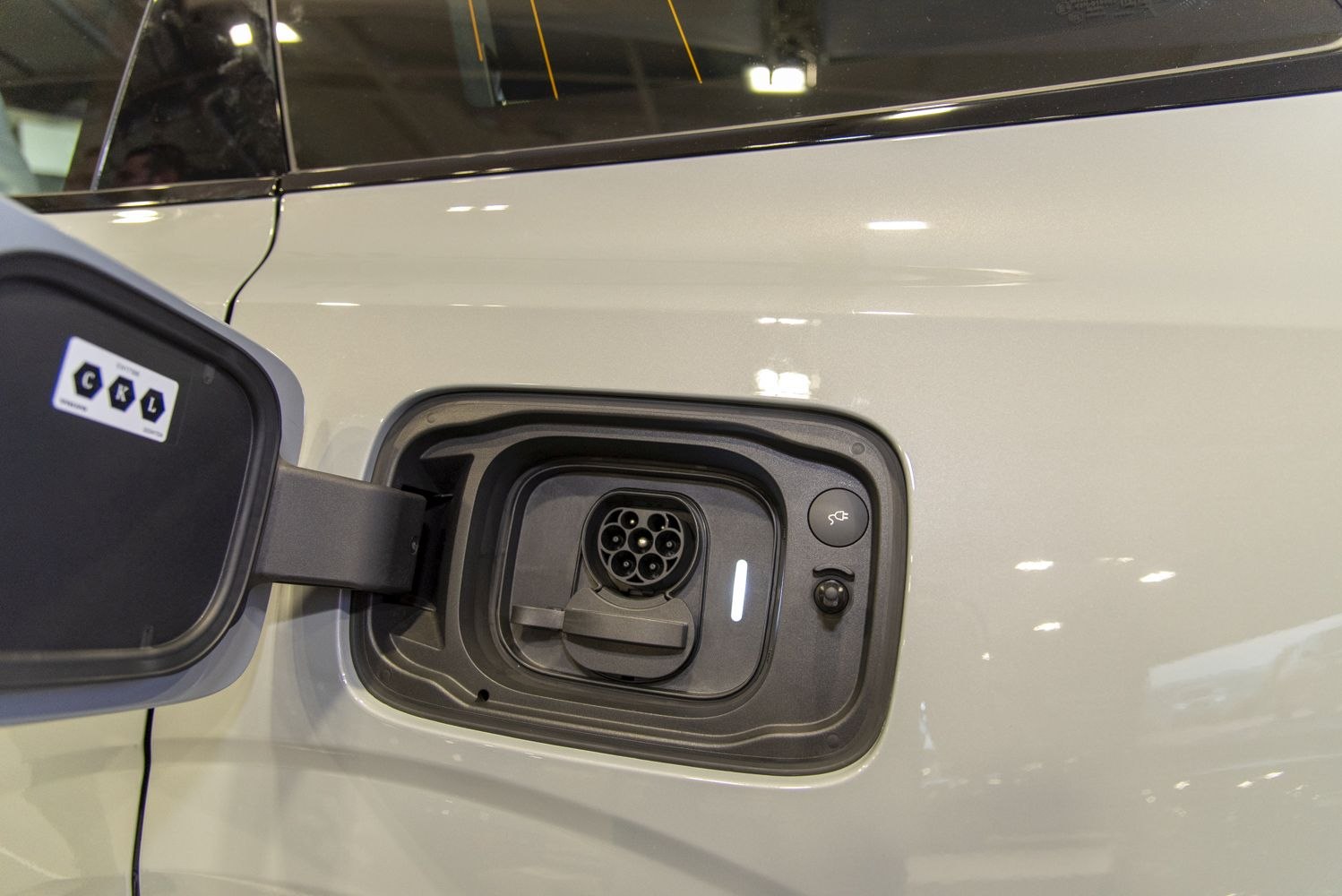 Close-up of an electric vehicle charging port and connector.