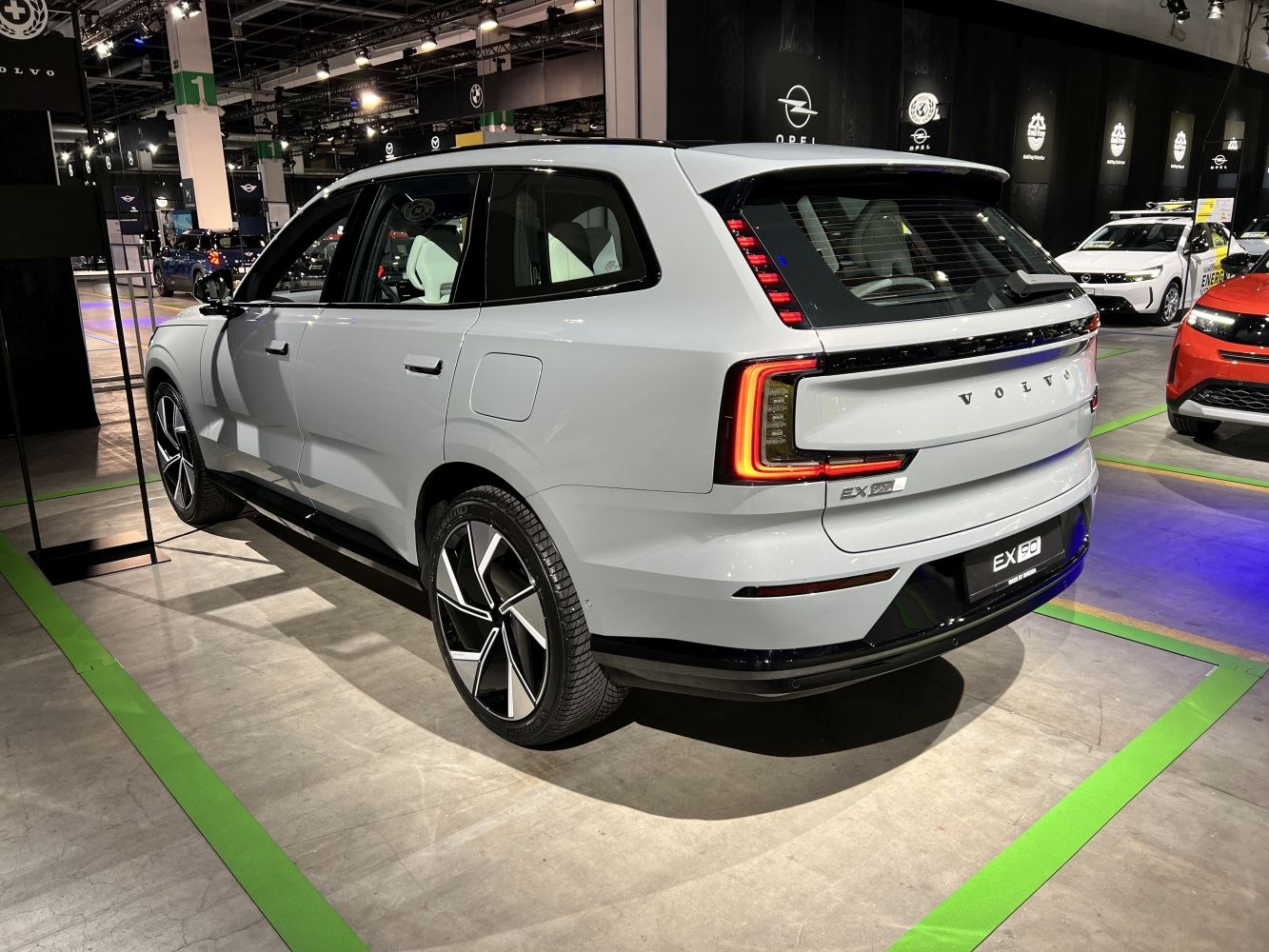 Modern electric SUV rear with vertical LED tail lights and alloy wheels.