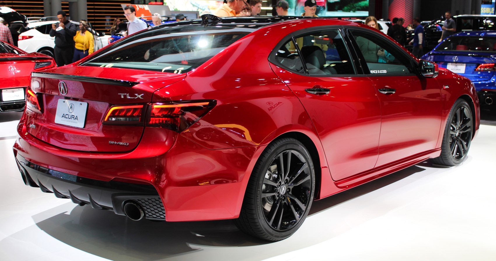 Rear three-quarter view with taillights and black alloy wheels