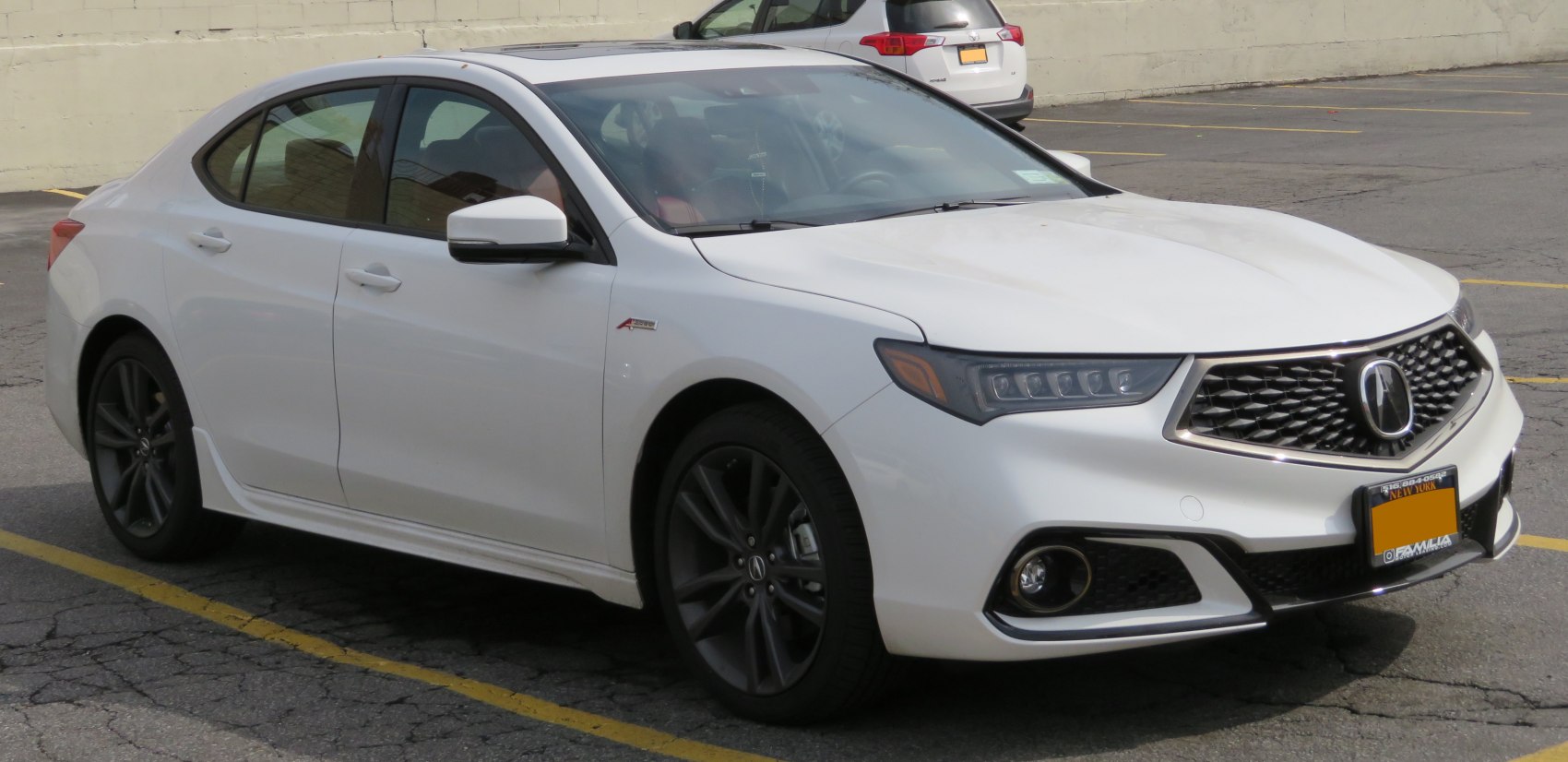 Front LED headlights and diamond-patterned grille on white sedan