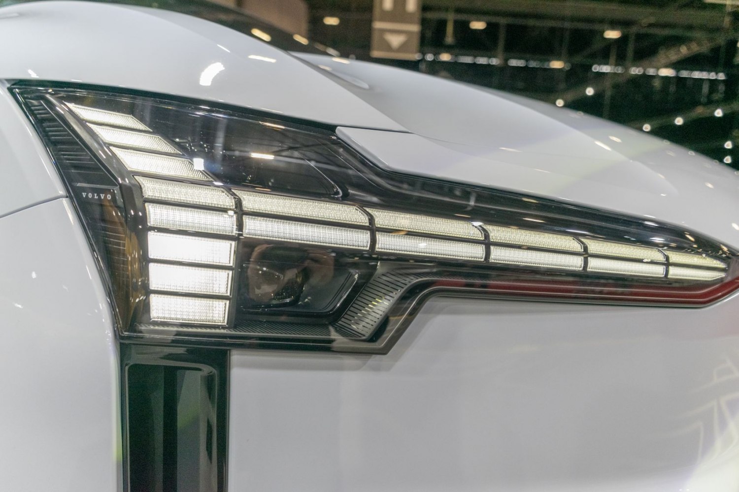 Close-up of modern multi-element LED headlight with segmented light bars and angular design
