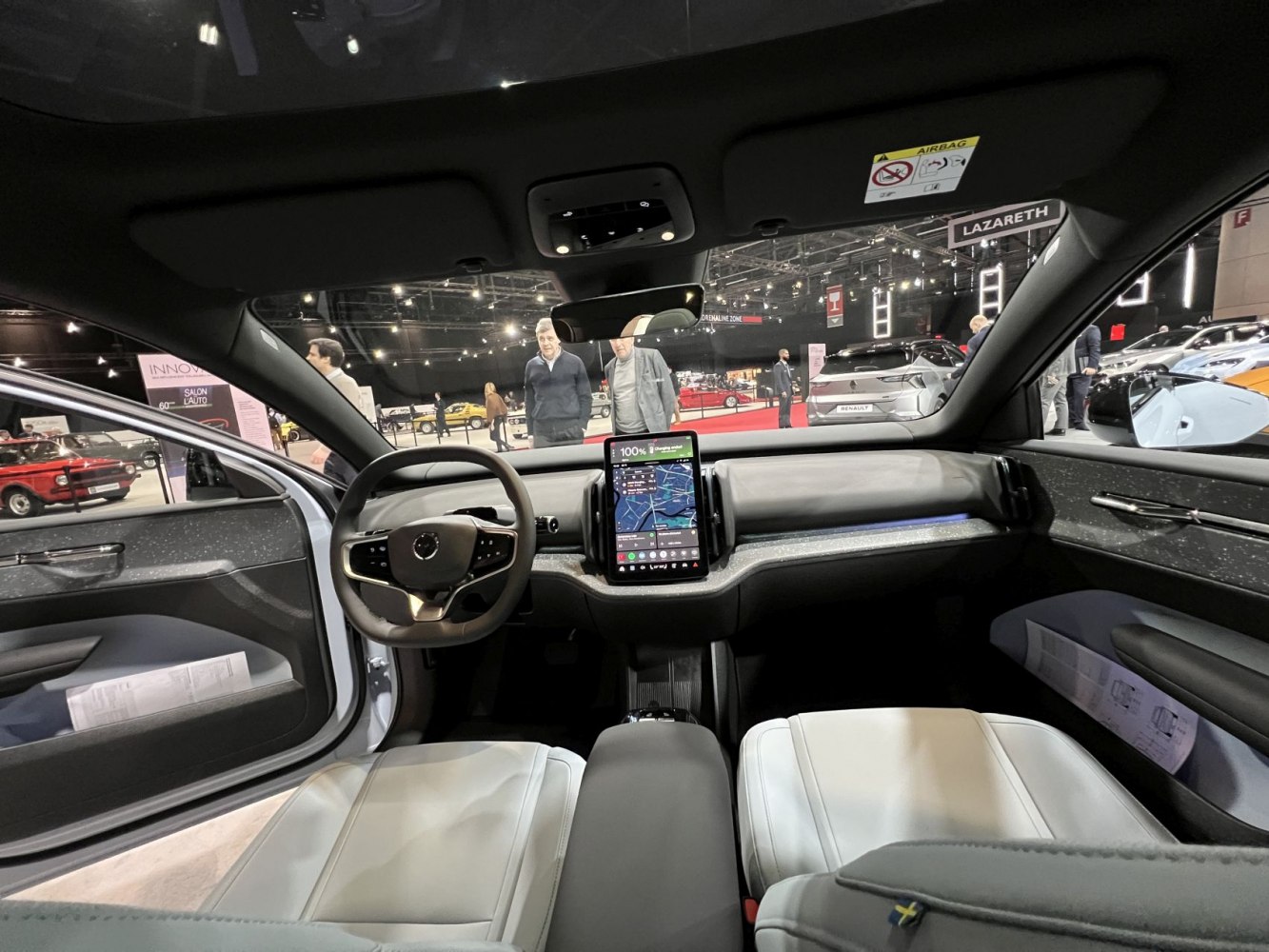Minimalist dashboard with central touchscreen and modern steering wheel