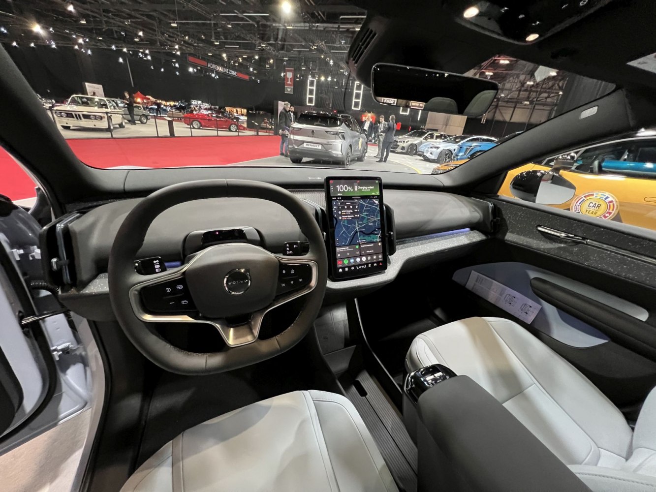 Steering wheel and central touchscreen display inside car interior