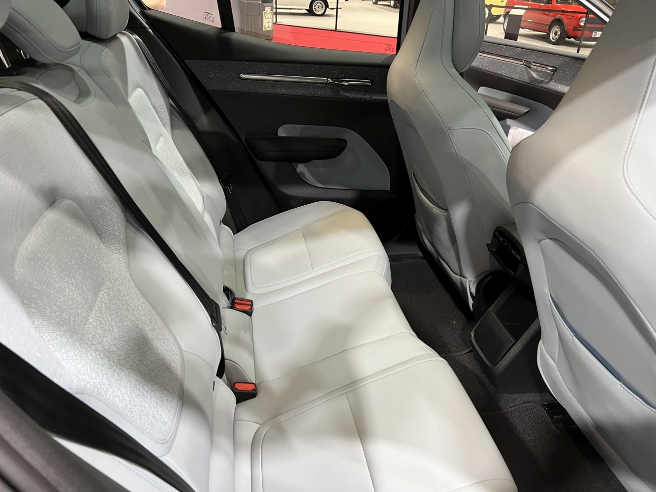 Rear seat with white upholstery and sleek door panel
