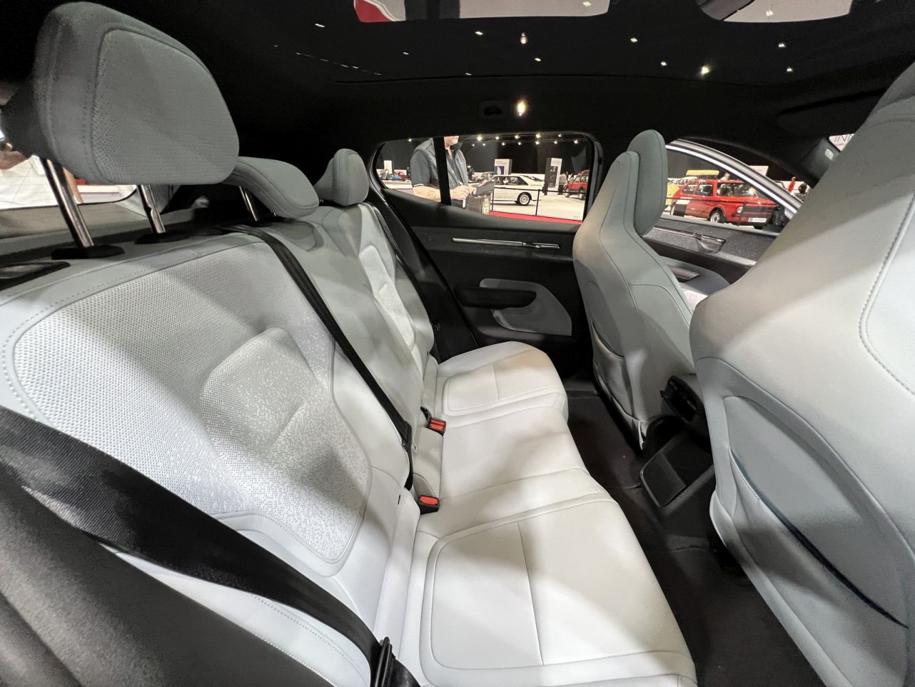 White upholstered rear seats with adjustable headrests and seat belts