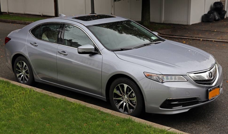 Silver mid-2010s sedan with LED headlights and alloy wheels