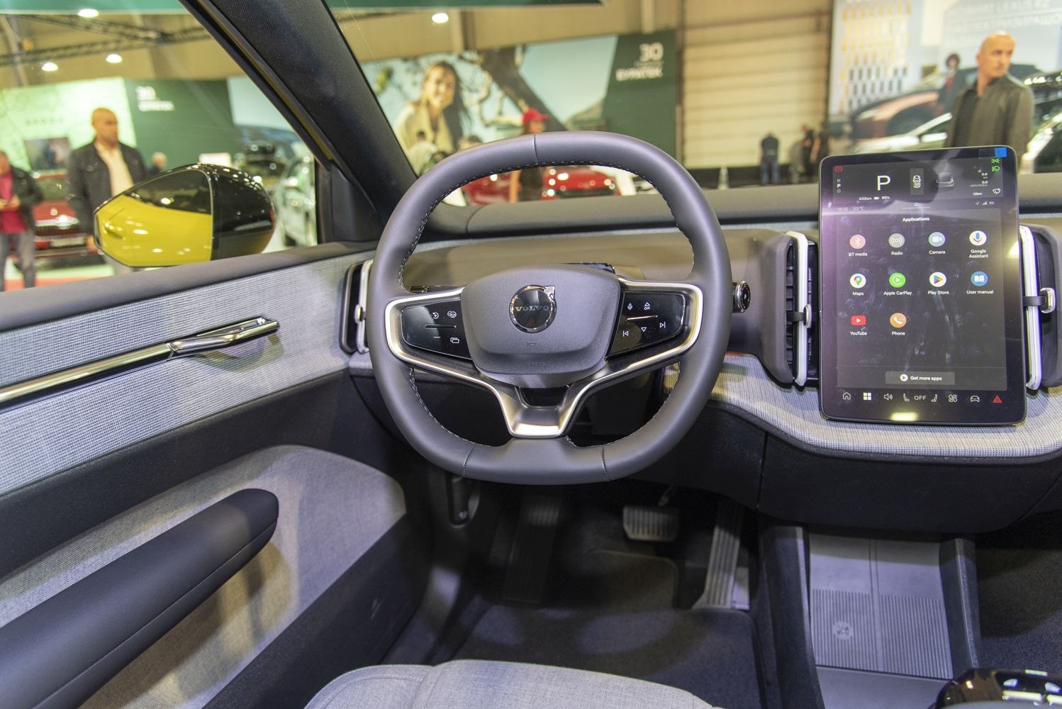 Digital steering wheel and large touchscreen infotainment display in modern vehicle interior
