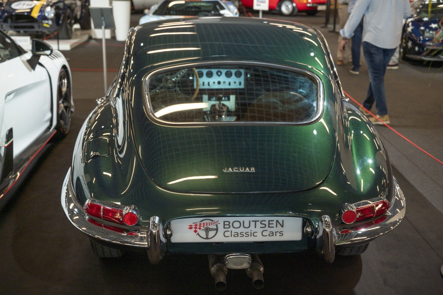 Green classic car rear view with iconic curves and detailed dashboard.